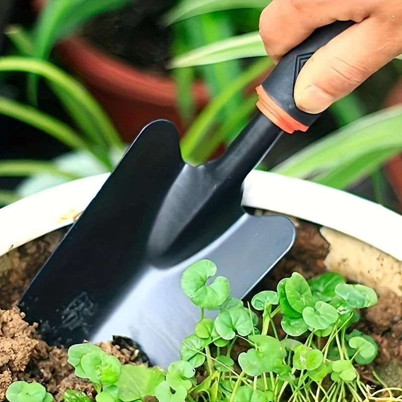 A Set of Four Outdoor Gardening Tools Including a Small Shovel for Planting Flowers, a Five-Pronged Rake, a Double-Headed Rake